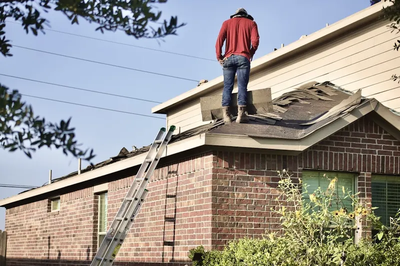 Professional roofer working on a residential roof in Princeton Meadows